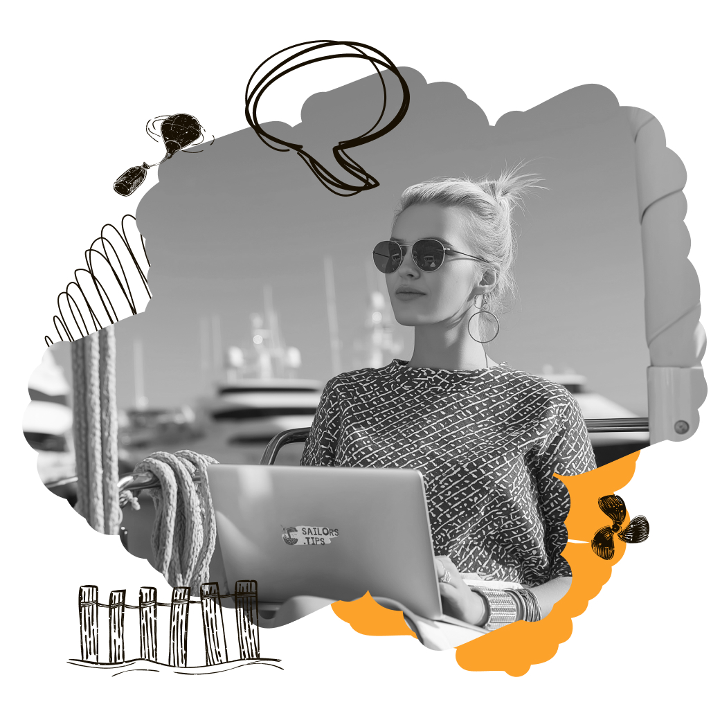 Sailor working on a laptop aboard a yacht