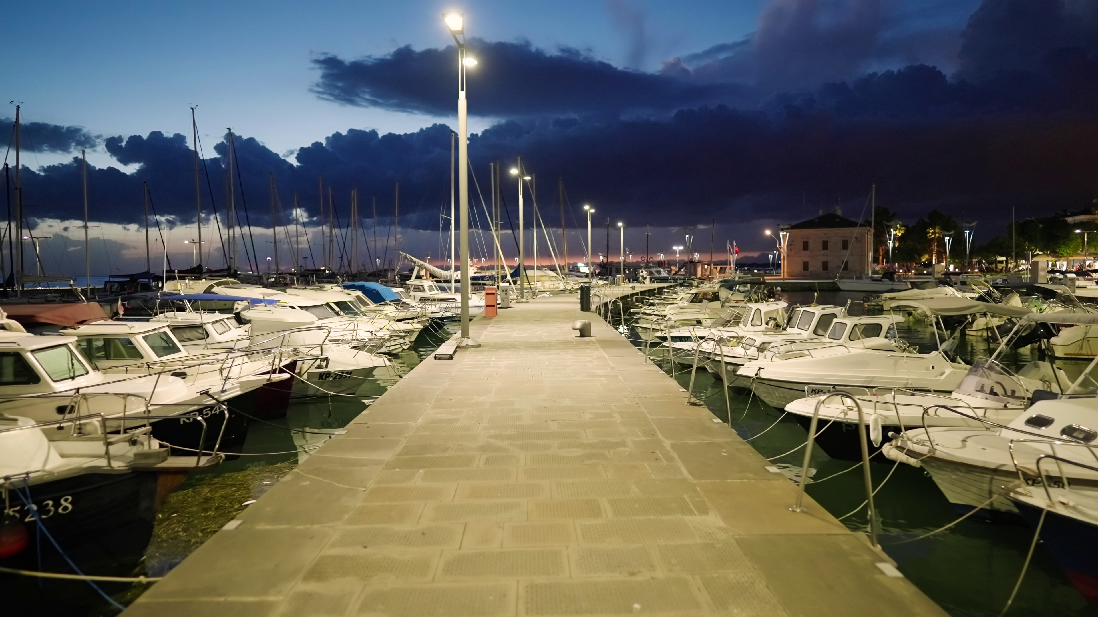 walking-on-sea-harbor-pier-with-parked-boats-and-yachts-at-night-4k-SBI-349501135.jpg